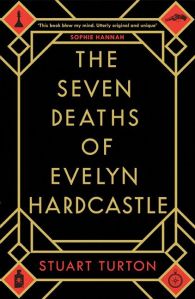 The cover of The Seven Deaths of Evelyn Hardcastle, with the title in gold words on black.